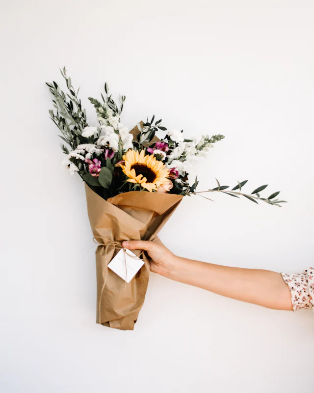 Wrapped bouquet handed over at the door